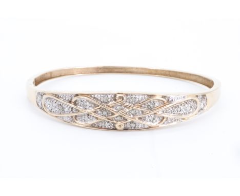 A diamond-set 9 ct gold hinged bangle, having a tapering faced with interlace framing millegrain precious white metal fields 