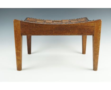 An oak arts and crafts stool by Arthur R Simpson of Kendal with leather strap top, bearing his "The Handicrafts, Kendal" Ivor