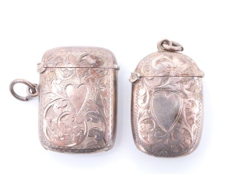 Two silver fob vesta cases, each of cushion form decorated with foliate scroll engraving centred by a heart shaped vacant car