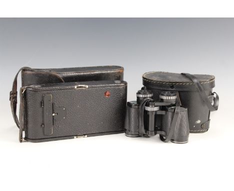An early 20th Century Kodak folding camera, in leather carry case, and a pair of Prinzlux 8 x 30 binoculars, former 12 x 25 x