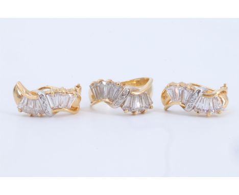 A 18 ct yellow metal and white stone demi parure, comprising a ring and pair of earrings, each of re-curved ribbon form and c