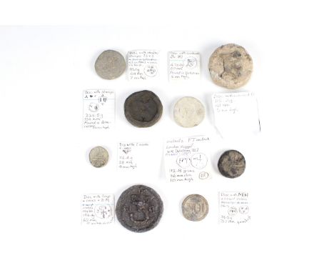 Eight Medieval lead trade weights, comprising a cast disc bearing a dagger flanked by 'DM', a bun bearing a lombardic 'R' fou