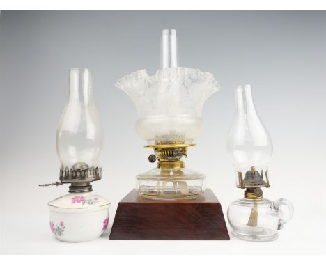A Victorian twin wick oil lamp, having a faceted reservoir and etched crinoline shade, in a later base, together with a trans