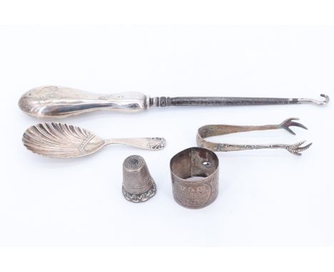 A group of silver and white metal compromising a clawed sugar tong, Levi &amp; Salaman, Sheffield, 1921, a caddy spoon, Rober