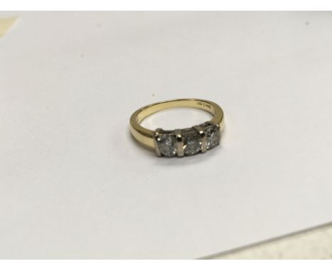 An 18carat gold ring inset with three brilliant cut diamonds. Ring size L