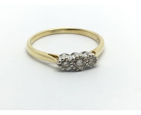 An 18carat gold ring set with three diamonds Approximately 0.20 of a carat.ring size T-U