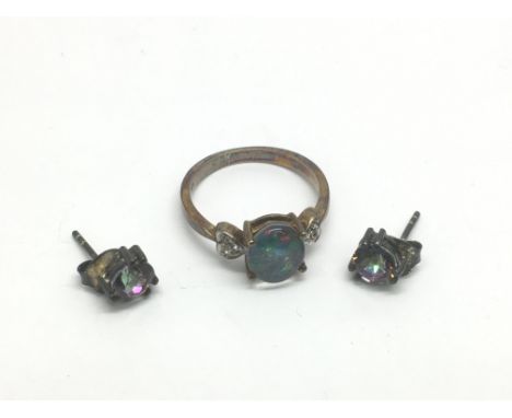 A pair of opal earrings and an opal doublet ring.