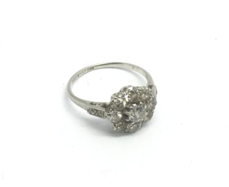 A platinum and diamond cluster ring, approx 2.4g and approx size J-K.