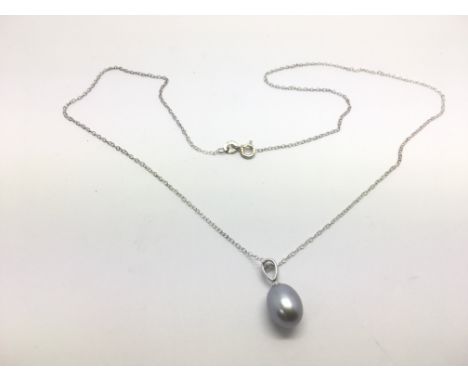 A silver necklace with attached pearl pendant.