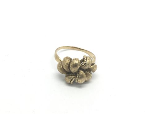 A gold ring marked 585 in the form of asymmetrical foliate scrolls, approx 6.4g and approx size U-V.