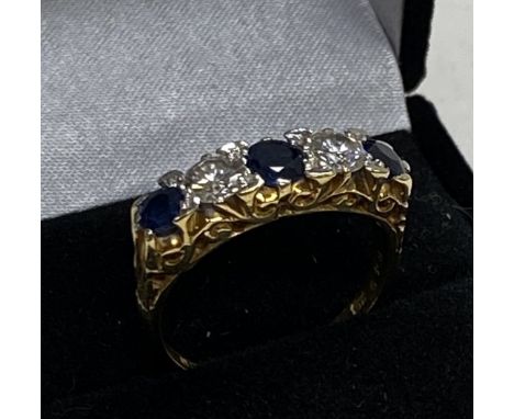 A heavy 18ct gold sapphire and diamond 5 stone ring, (S). 6.3g.