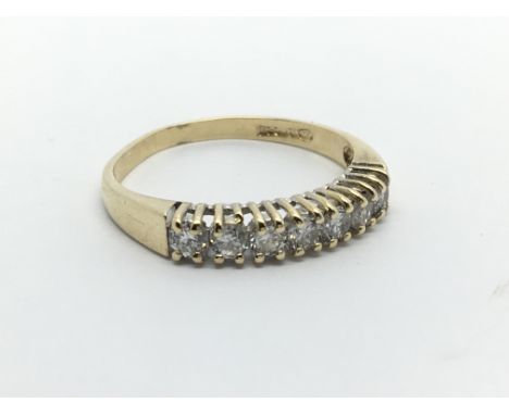 A 9carat gold ring set with a row of seven diamonds ring size O.