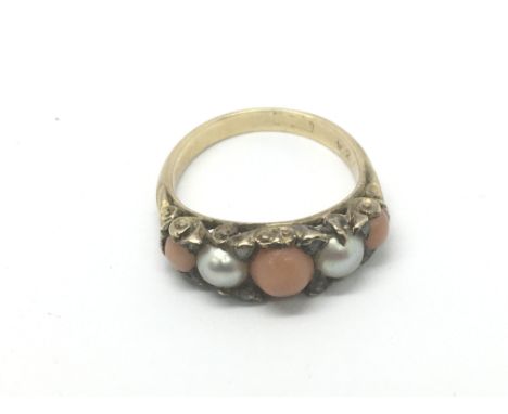 A gold ring set with pearl, diamond and coral, approx 3.2g and approx size I-J.