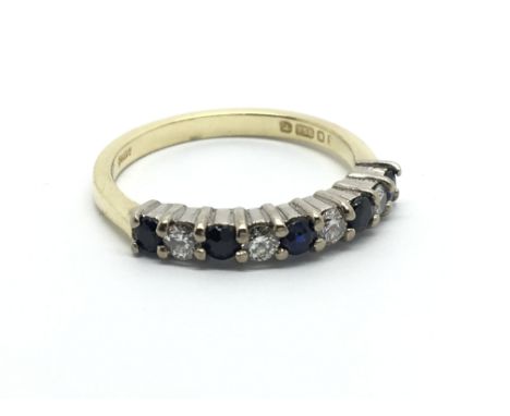 An 18carat gold ring set with alternating sapphire and diamonds ring size K-L