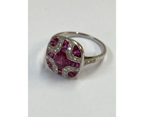 Platinum Art Deco style panel ring set with oval cut and calibre cut rubies and RBC diamonds