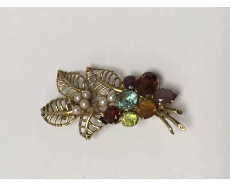 An unmarked gold brooch of floral form with Pearl and multi gem stone inset .