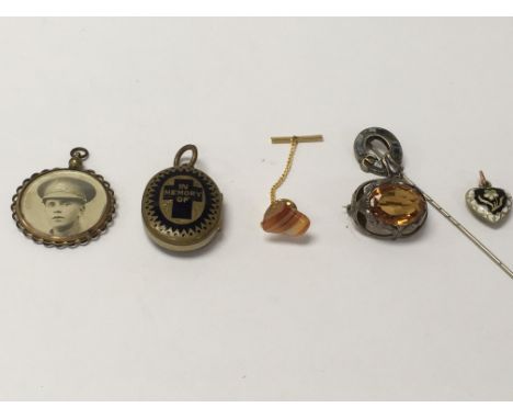 A six piece collection comprising of a World War 1 pendant, a locket, a silver Scottish stick pin, two brooches and one other