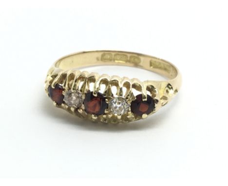 A vintage 18ct yellow gold ring with alternating garnets and diamonds, approx size L/M