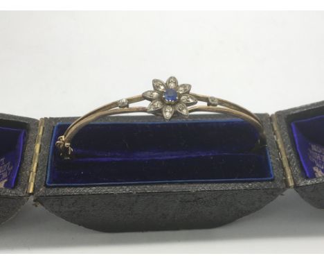 A vintage gold bangle set with sapphire and diamonds, approx 10g.