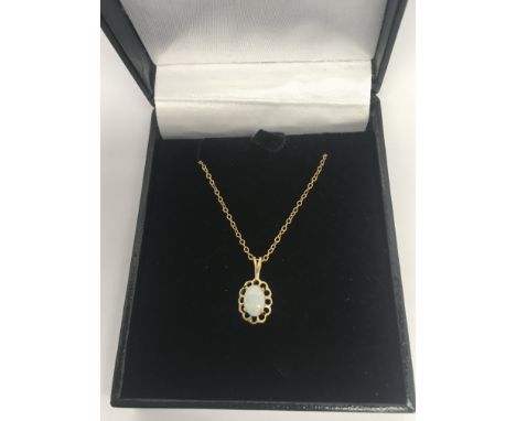A 9ct gold opal pendant on a 9ct gold chain