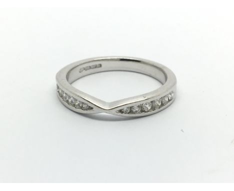 An 18carat white gold ring.a half hoop eternity ring set with brilliant cut diamonds ring size L.