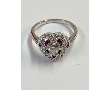 18ct white gold Victorian style heart shaped ring set with a central pear cut diamond surrounded by rubies and diamond with a