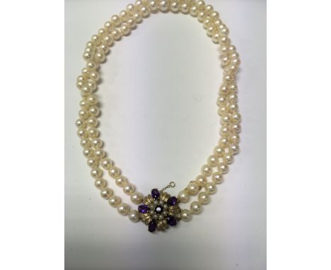 A double Pearl necklace with central 9 ct gold pendant inset with amethyst and seed pearls.