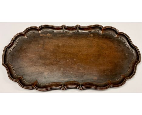A George II style Chippendale design mahogany shaped oval tray, pie crust border, 41.5cm wide 