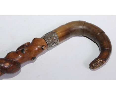 A 19th century walking stick, curved horn handle, the folk art cane carved and painted with a serpent, 87cm long 