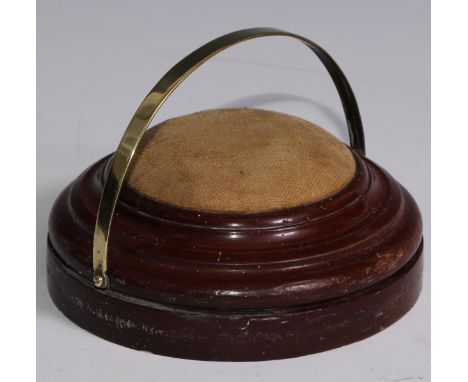 Treen - a 19th century turned mahogany table top pin cushion, brass swing handle, weighted base, 15cm diam, c.1850 