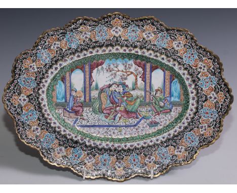 An Islamic Middle Eastern enamel shaped oval dish, painted in polychrome in the Persian taste with court musicians and figure