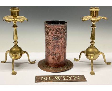 A pair of Arts and Crafts brass candlesticks, by Benham &amp; Froud, London, stylised leafy drip pan, shaped pad feet, 21.5cm