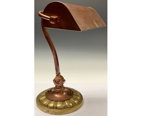 An early 20th century copper and brass desk lamp, adjustable shade and swan neck stem, fluted circular base, 39cm high, c.192