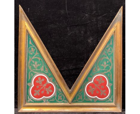 A 19th century Gothic Revival lacquered brass and enamel architectiral mount, the spandrels decorated in the manner of Pugin 
