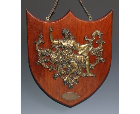 A 19th century gilt metal appliqué, cast as a muse allegorical of knowledge, the mahogany shield with plaque inscribed Souven