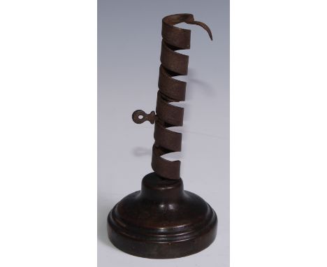 A 19th century iron spiral candlestick, fruitwood base, 20cm high 