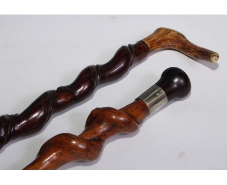 A 19th century twisted hazel walking stick, hardwood knop pommel, 88.5cm long; another, stag antler handle, 91cm long (2) 