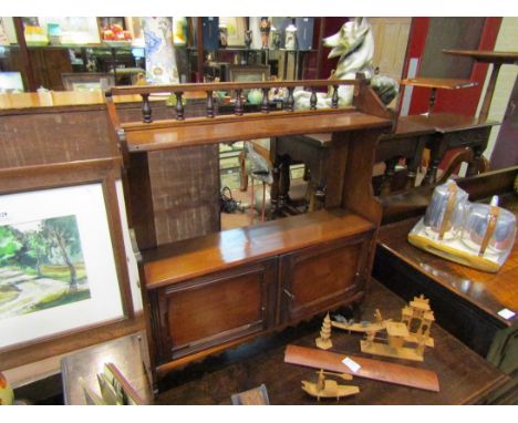 A late Victorian walnut wall hanging shelf with turned spindle gallery over two doors with key, 63cm x 58cm x 14cm