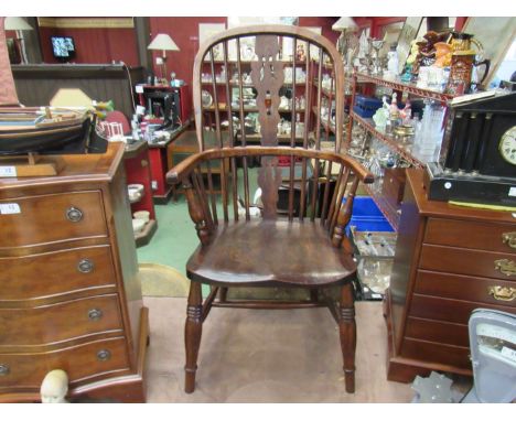 Stamped "H.S." circa 1860 an elm and oak stick back Windsor elbow chair the hoop back with fret central splat over ring turne
