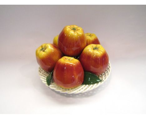 A Majolica style ceramic table centrepiece of apples in a lattice basket