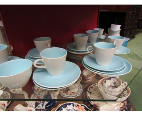 A Poole two tone pottery teaset comprising of eight cups and saucers, eight side plates, sugar and cream