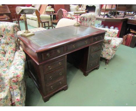 A late Victorian mahogany twin pedestal writing desk the tooled leather insert over nine drawers on bracket feet, 121cm x 68c