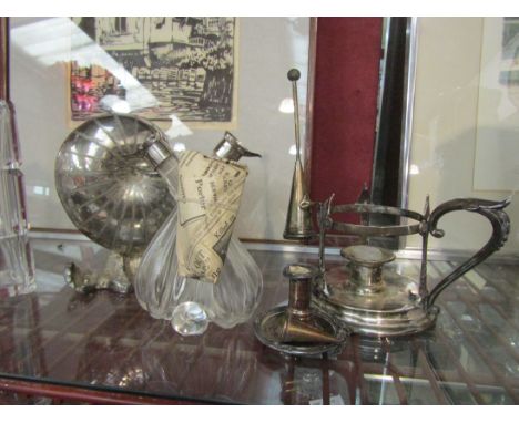 A conch shell form spoon warmer, chamber stick with snuff, silver rimmed oil dispenser and candlestick (4)