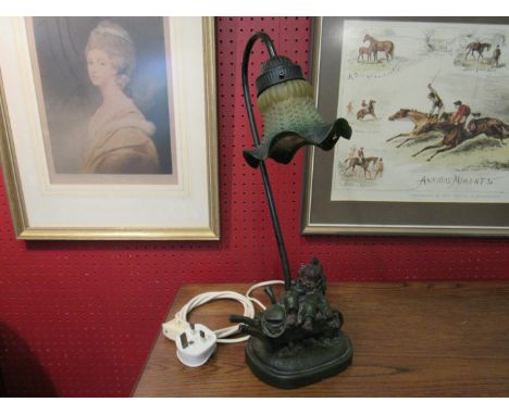 A figural lamp as a girl in a wheelbarrow, with fitted shade, 43cm tall