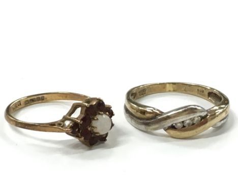 Two 9 carat gold rings, one set with small diamonds, one set with garnets and an opal.
(R5)