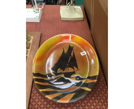 A Poole Pottery Aegean oval charger decorated with a yacht.