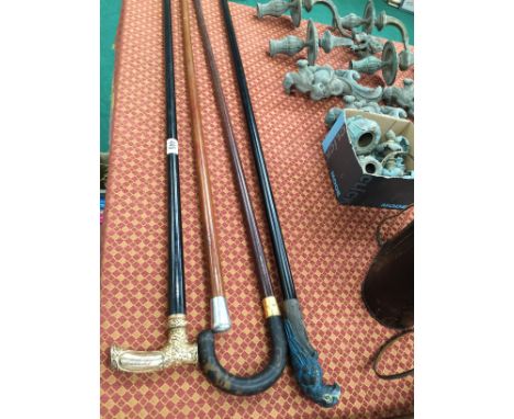 Five various walking sticks to include a silver topped Malacca walking cane and a horn handled walking stick.