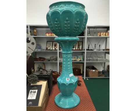 An Ault Pottery pale blue glazed jardiniere on stand (chipped).