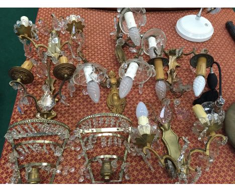 A collection of various brass and glass wall light fittings.