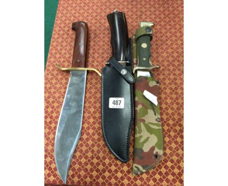 A modern Bowie knife by Western, Boulder, U.S.A. together with another large wooden handled knife in black leather sheath and